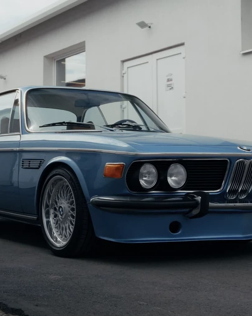 Close portrait crop of a restored blue classic BMW