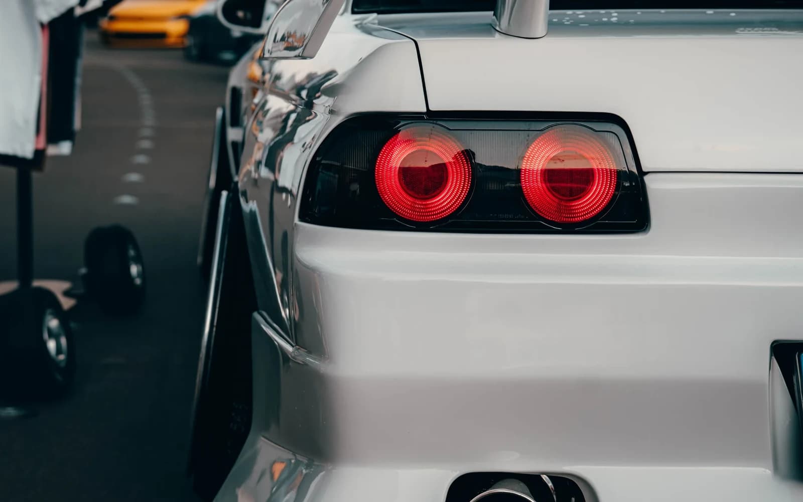 Rear-light and widebody detail of a white modified coupe at Ultrace 2025