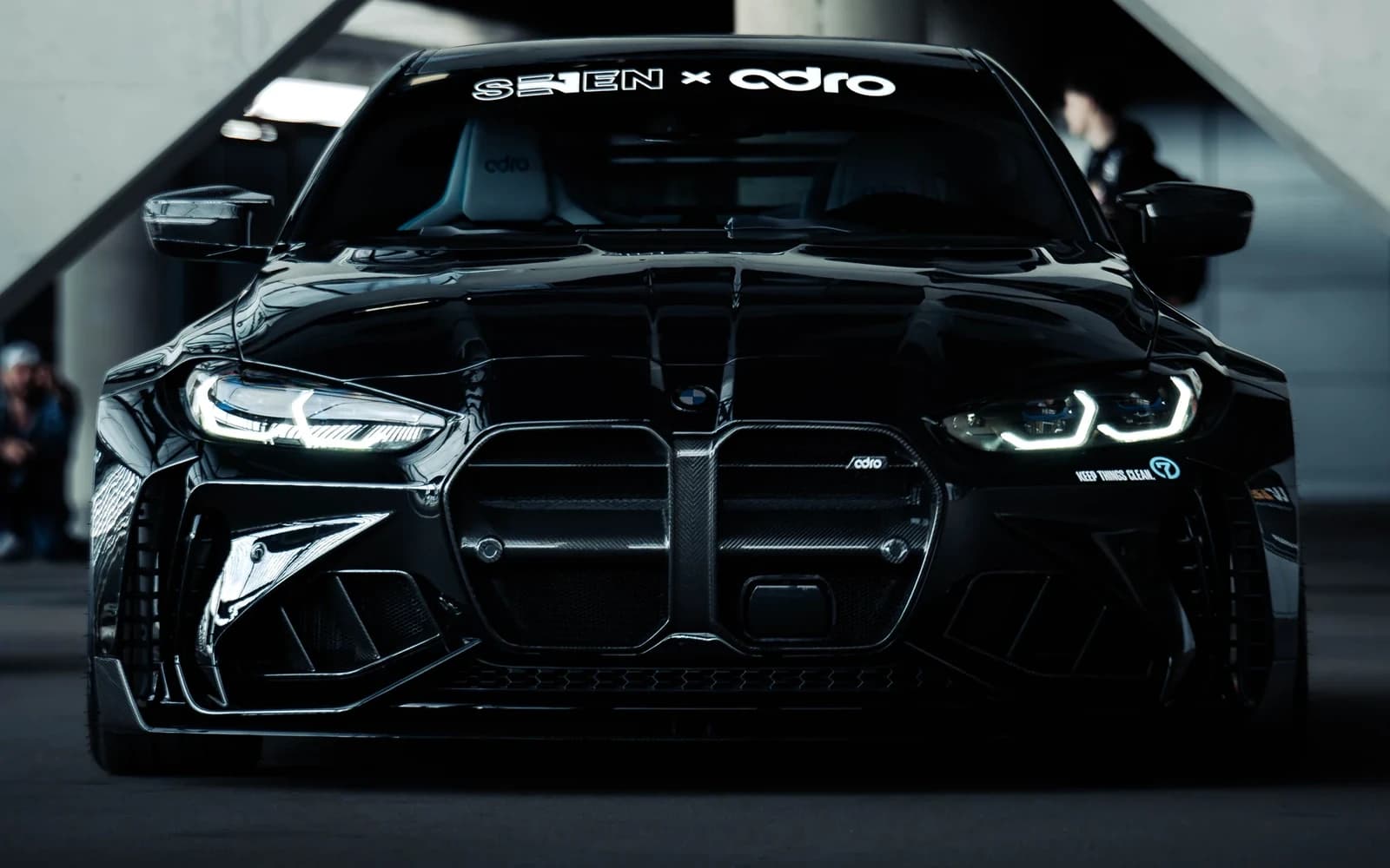 Black BMW framed beneath the architecture of Tarczyński Arena at Ultrace 2025