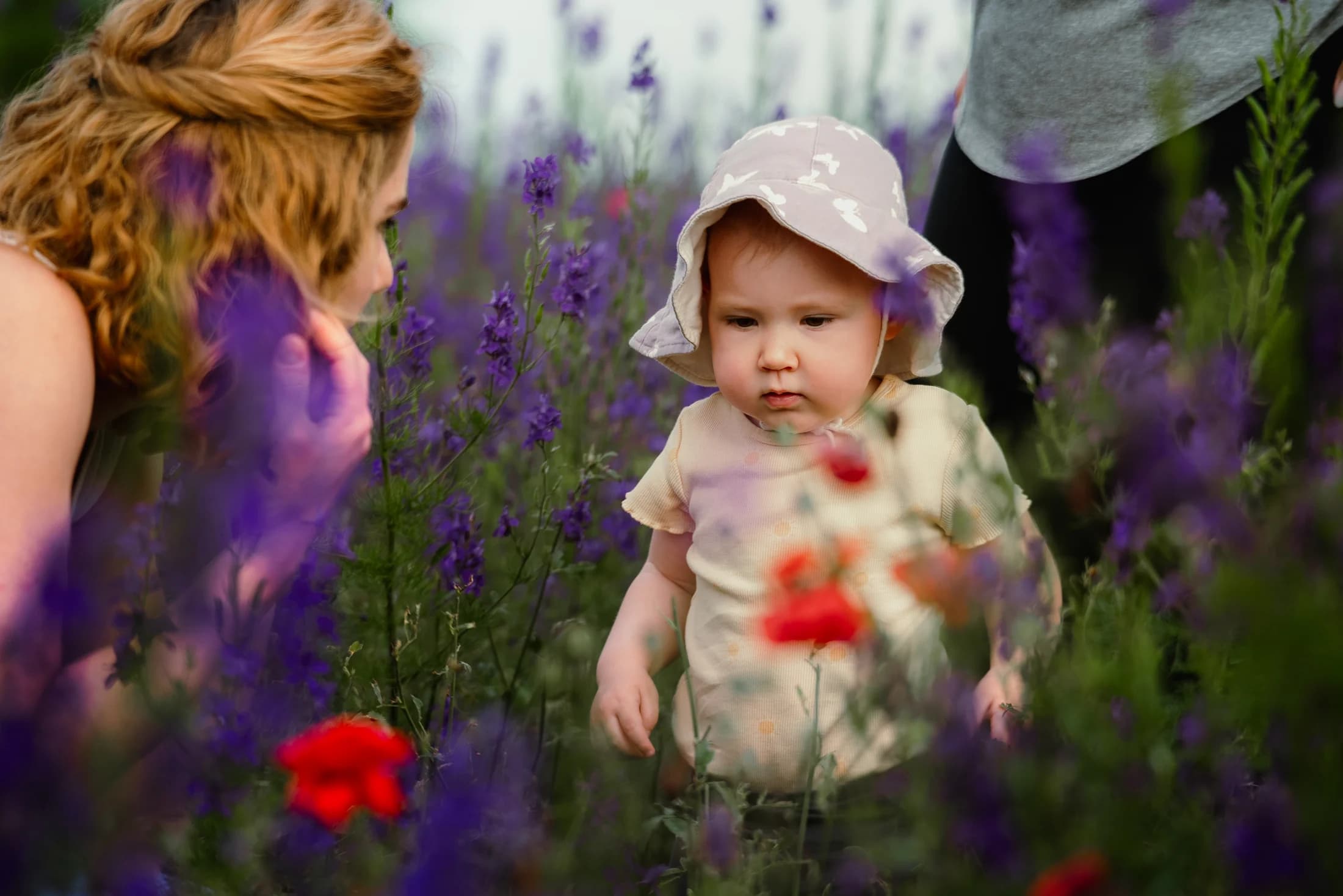 Young child standing among colorful wildflowers