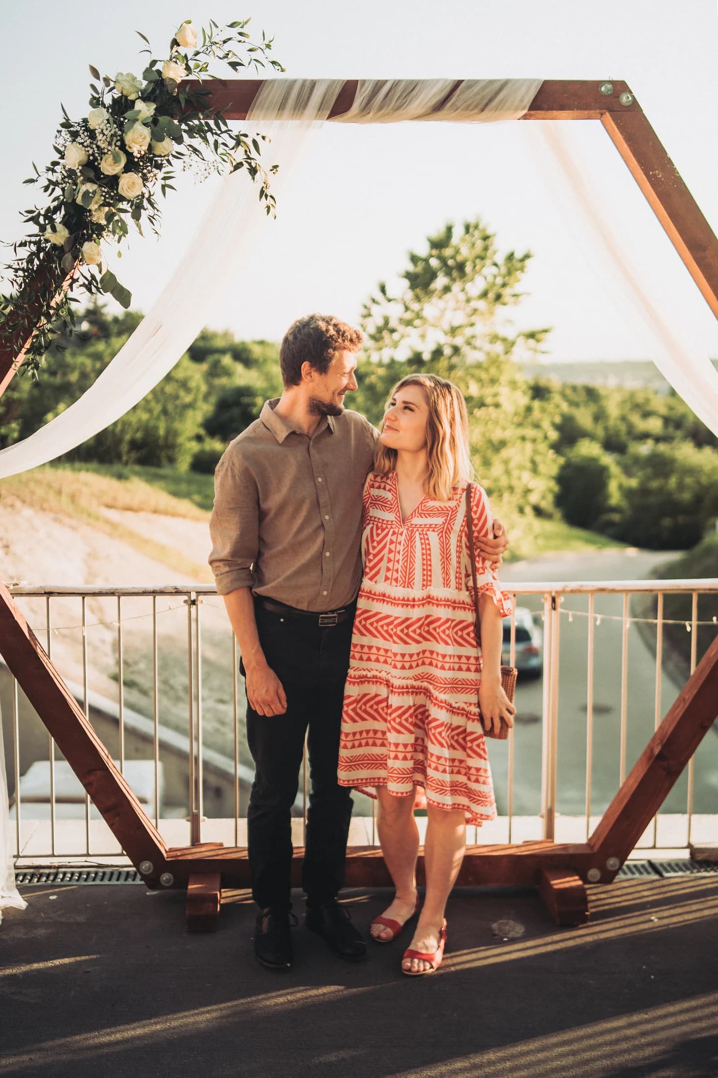 Couple standing together on a terrace in warm evening light