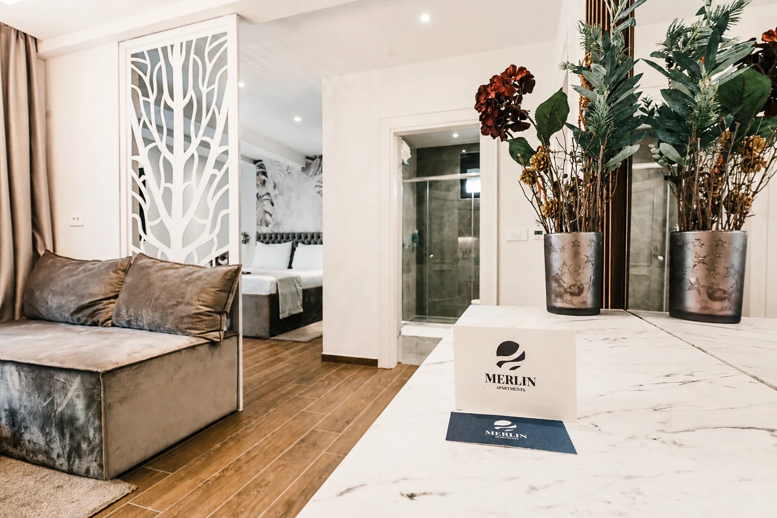 Merlin Apartments interior with branded guest materials and decorative details
