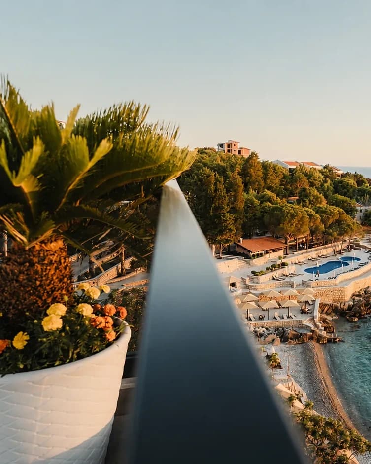 Balcony detail with plants and a view along the Dobra Voda coastline