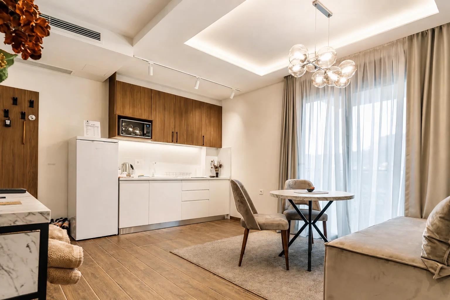 Open-plan apartment interior with kitchen, dining area and living space