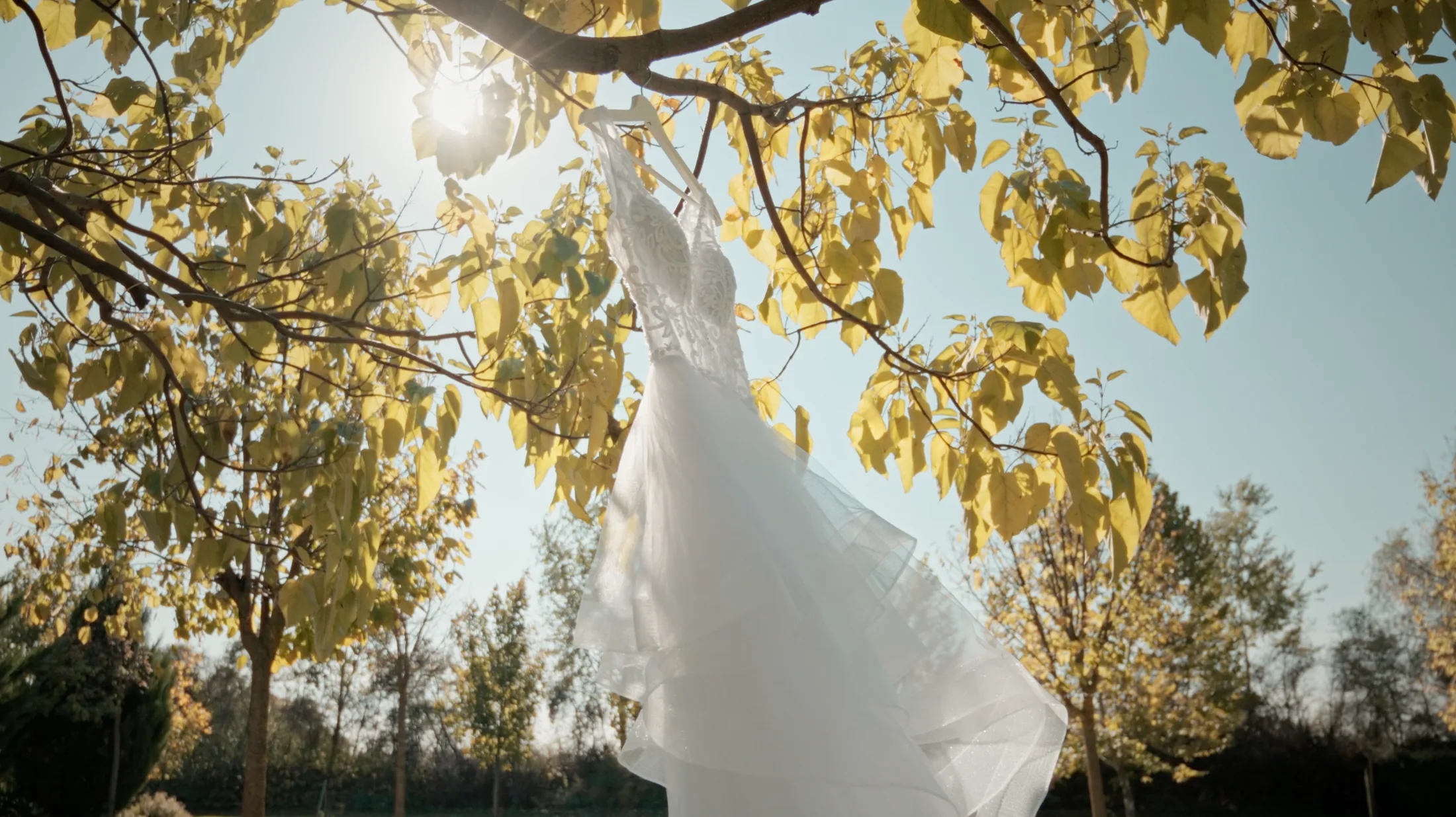 Anó’s wedding dress hanging in autumn sunlight before the ceremony