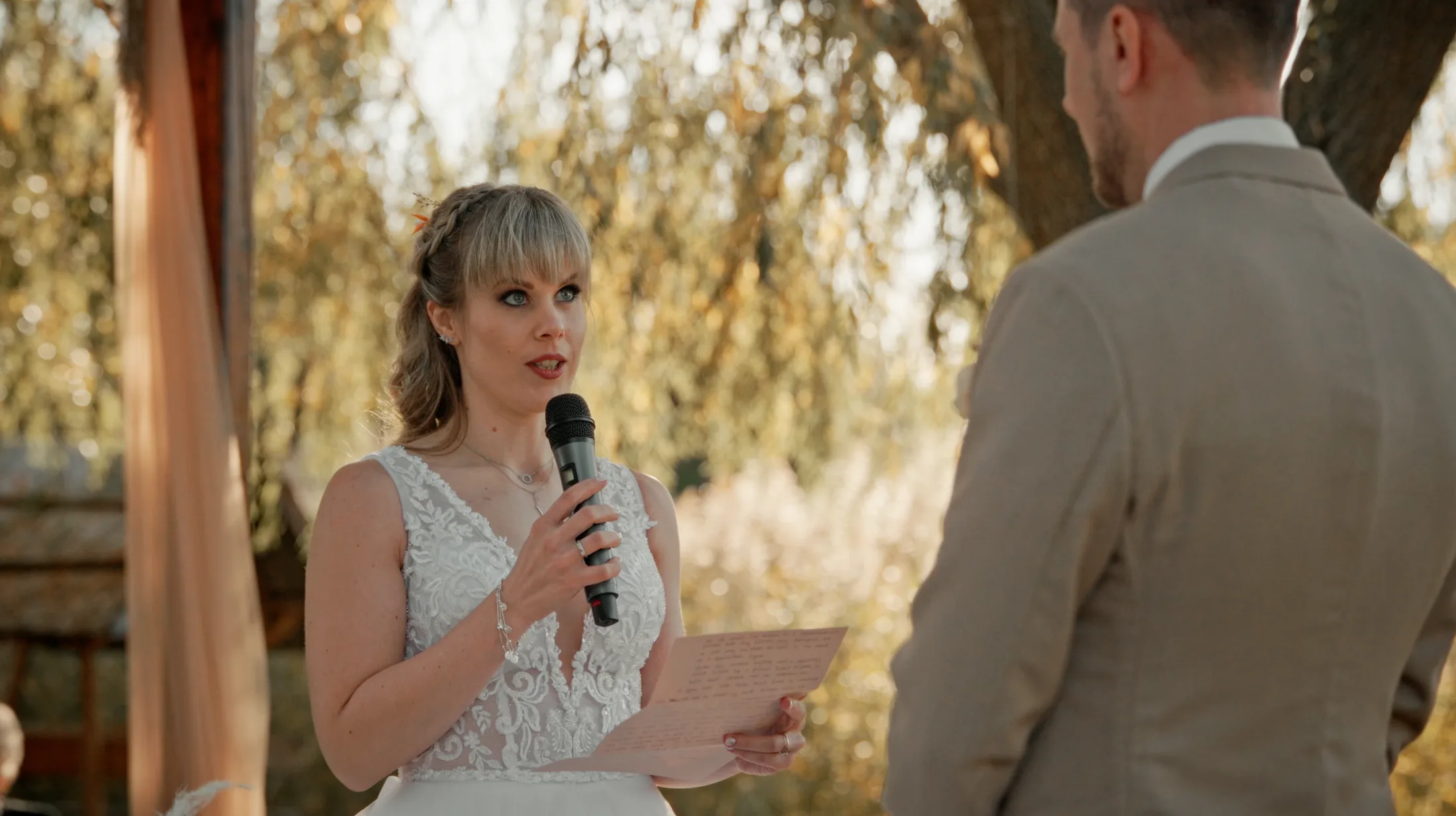 Anó reading her vows to Bálint during the outdoor ceremony
