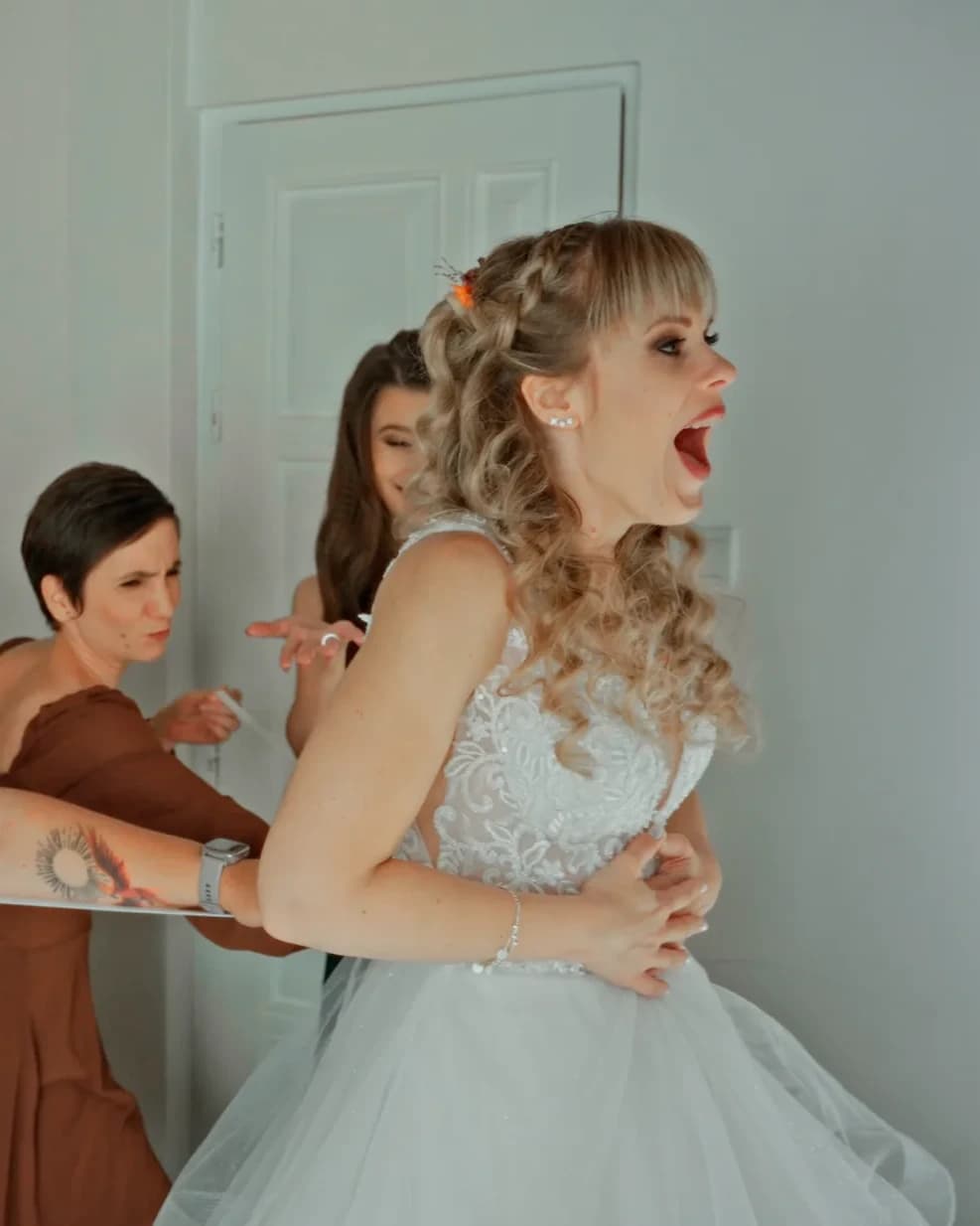 Anó laughing with friends during the final moments of getting ready