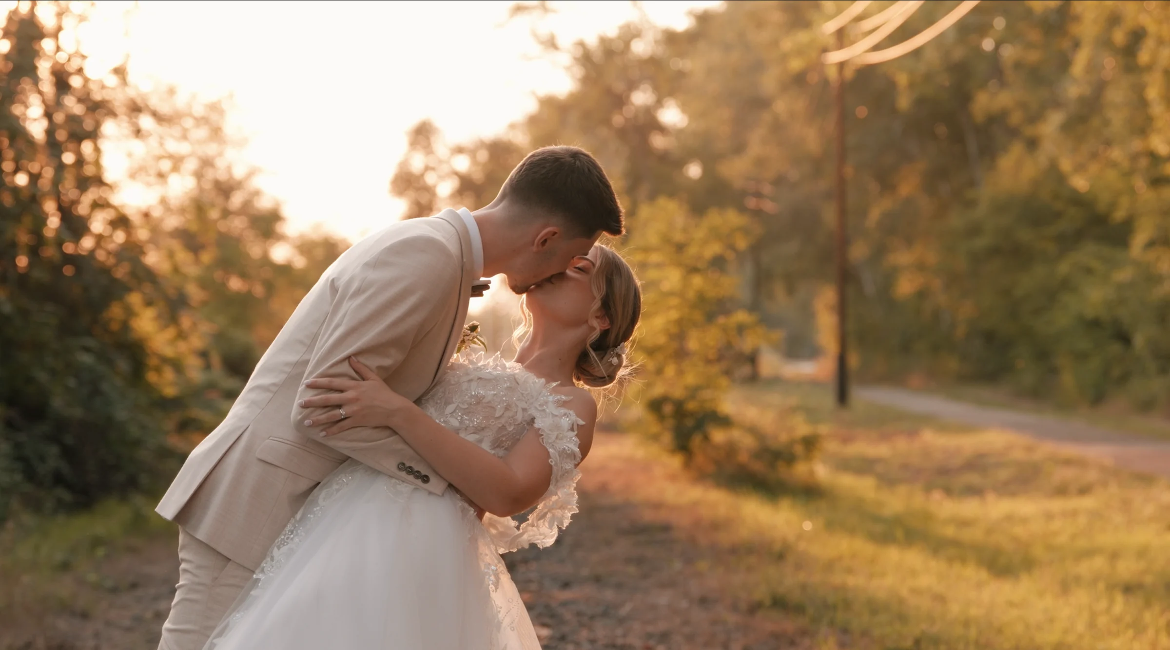 Fanni and Kristóf kissing in warm golden-hour light at Csereerdő Szíve